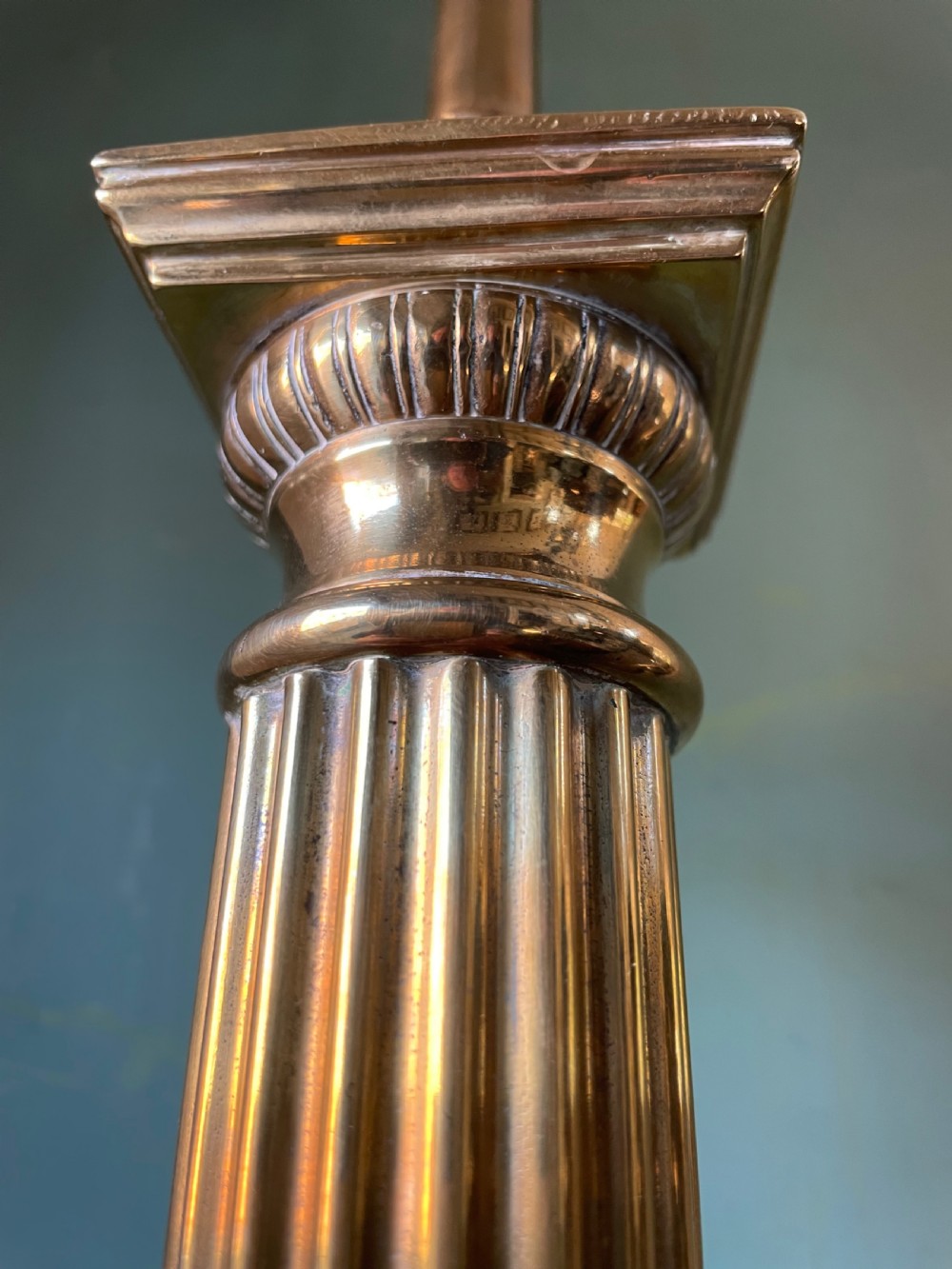 A late 19th-century brass table lamp styled as a classical fluted column with a stepped base and laurel wreath detail. View XIII