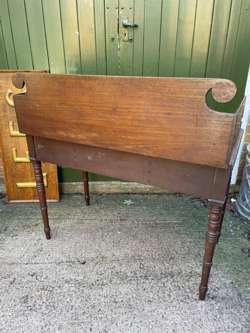 An early 19th-century George III mahogany kneehole dressing table with a scroll-ended three-quarter gallery back, multiple drawers, and ring-turned legs. View IX