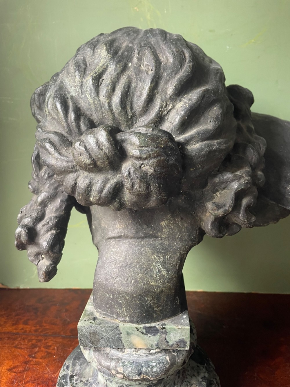 A 19th-century verdigris bronze head study of Hypnos featuring a winged temple, mounted on a round variegated green marble base. View VI