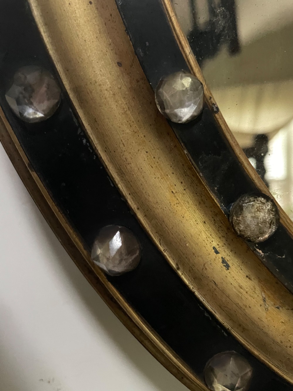 Mid C19th Irish oval mirror in ebonised and parcel-gilt moulded profile frame set with a double band of facetted cut-glass cabochons.  View VIII