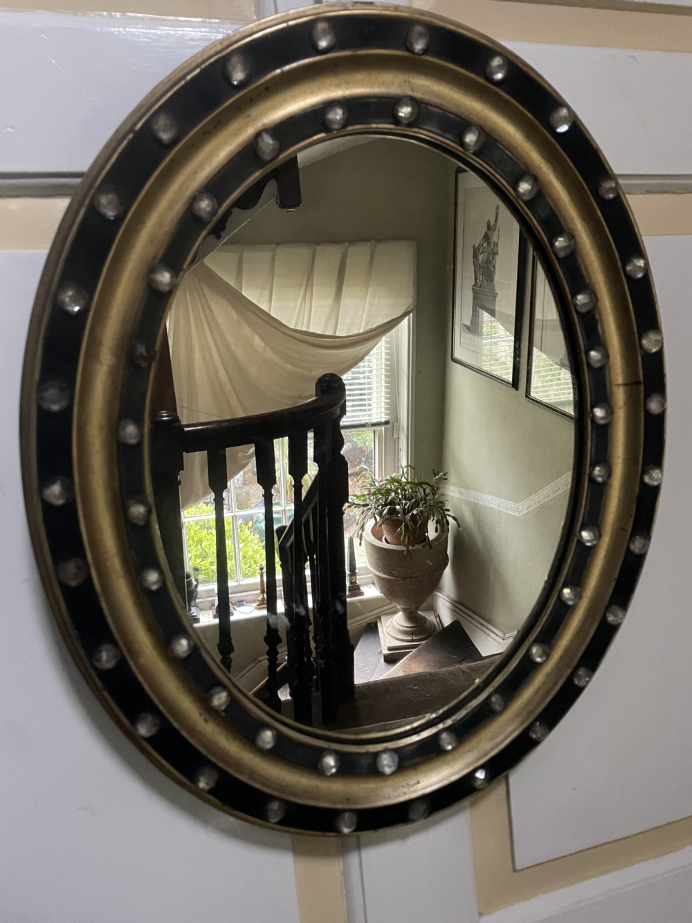Mid C19th Irish oval mirror in ebonised and parcel-gilt moulded profile frame set with a double band of facetted cut-glass cabochons.  View XII