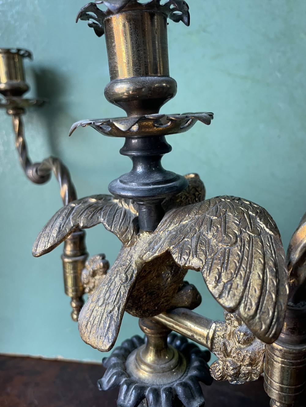 An early nineteenth-century Regency period three-light candelabra featuring adjustable swivelling arms, a central eagle figure perched above a fluted bronze column, and a square plinth base. View XX