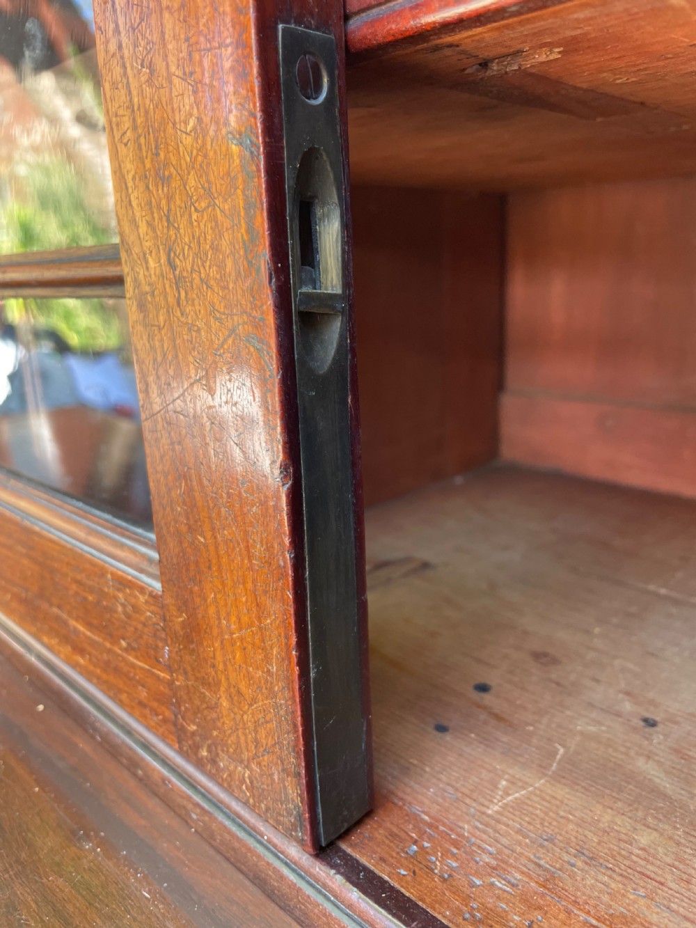 An early nineteenth-century mahogany library bookcase featuring astragal-glazed upper doors and double panelled lower doors. View VII