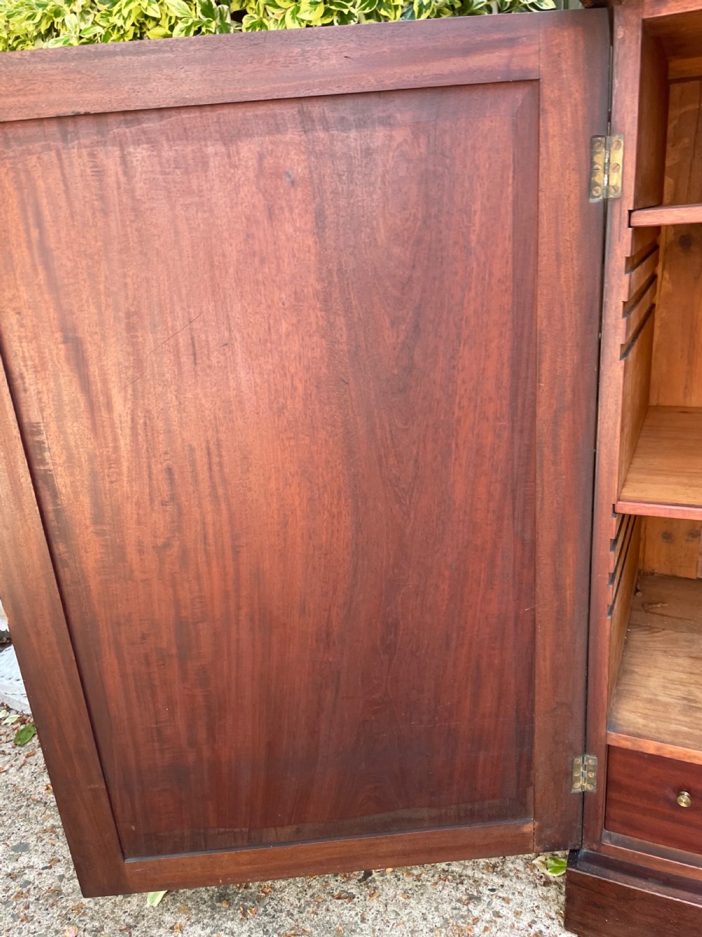 An early nineteenth-century mahogany library bookcase featuring astragal-glazed upper doors and double panelled lower doors. View X