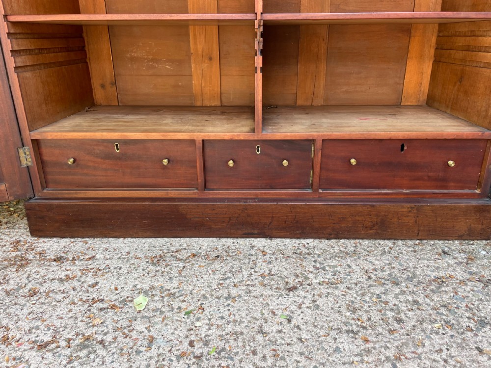 An early nineteenth-century mahogany library bookcase featuring astragal-glazed upper doors and double panelled lower doors. View XII