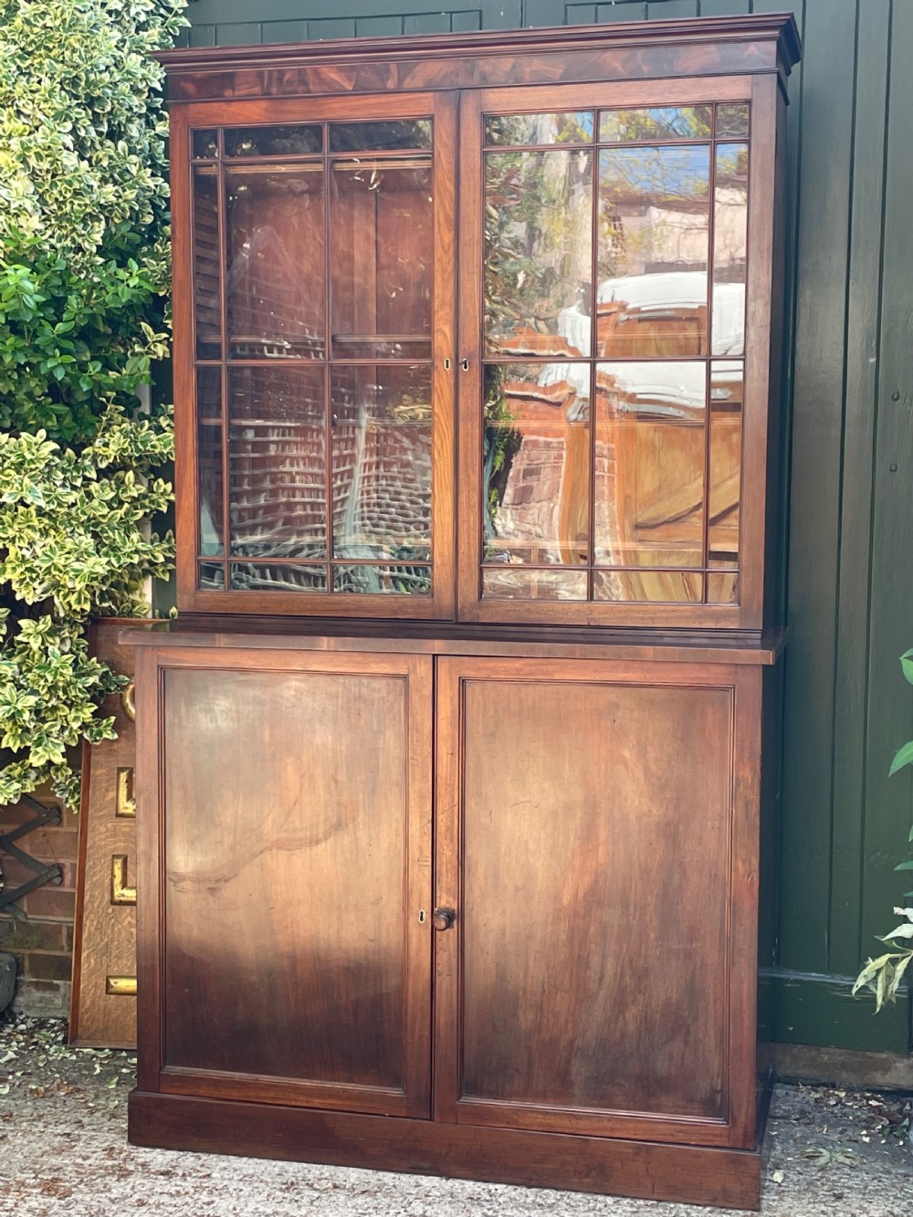 An early nineteenth-century mahogany library bookcase featuring astragal-glazed upper doors and double panelled lower doors. View XXI