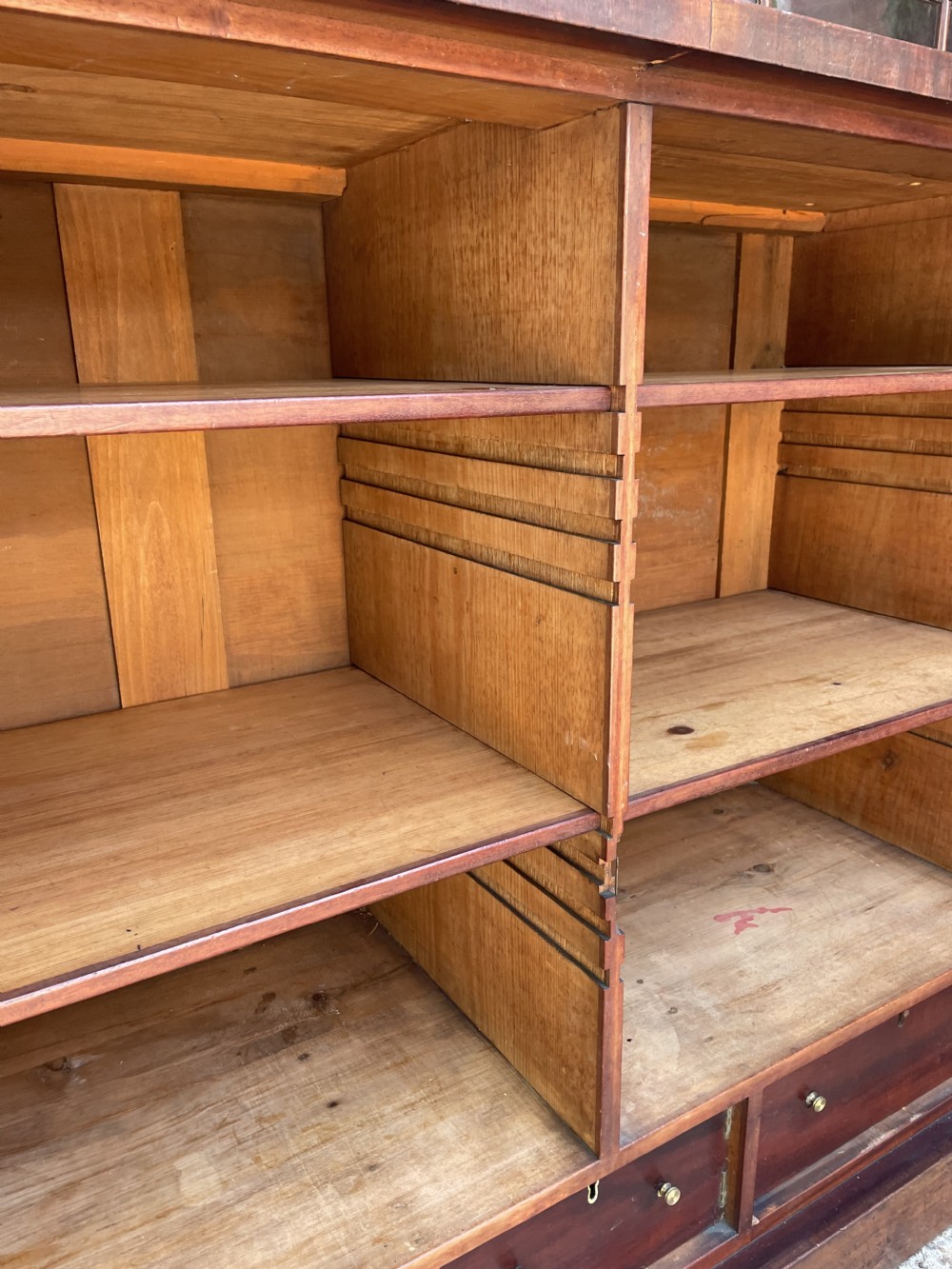 An early nineteenth-century mahogany library bookcase featuring astragal-glazed upper doors and double panelled lower doors. View XXIII