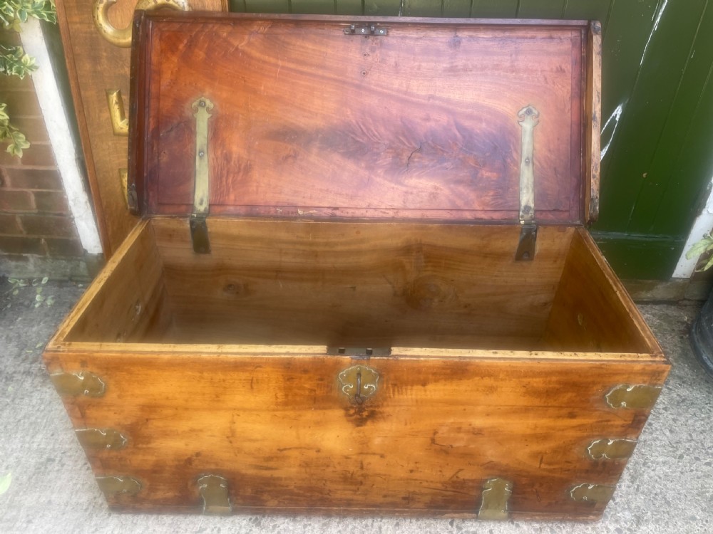 A mid-eighteenth century solid cedar trunk featuring decorative brass corner brackets, brass straps, and a central brass keyhole escutcheon. View IX
