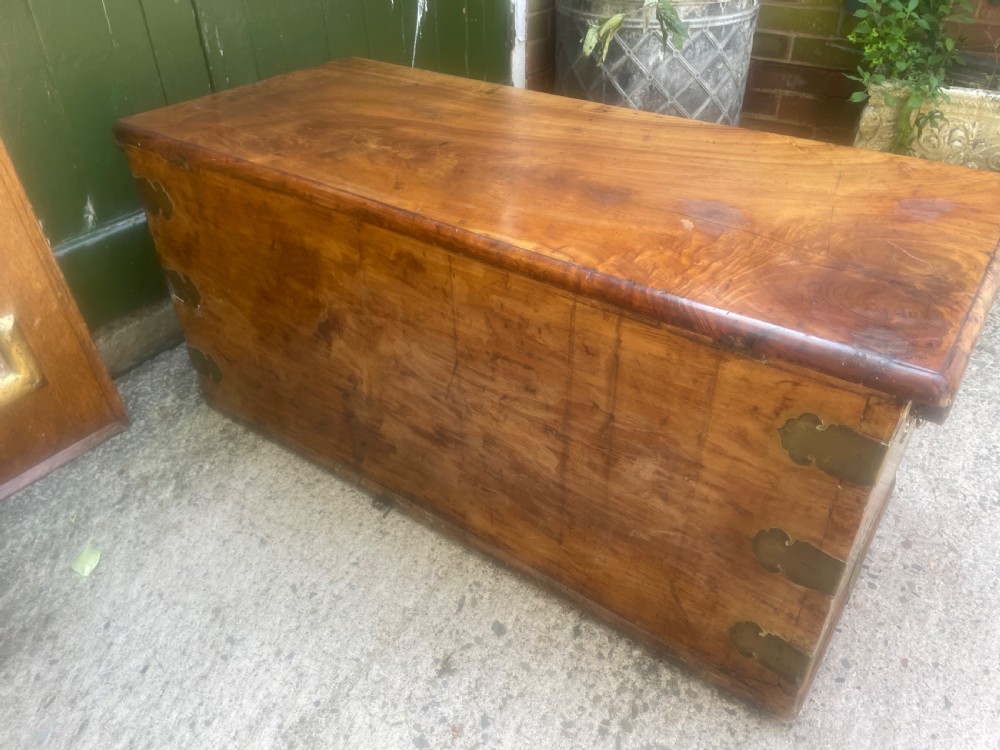 A mid-eighteenth century solid cedar trunk featuring decorative brass corner brackets, brass straps, and a central brass keyhole escutcheon. View XIII