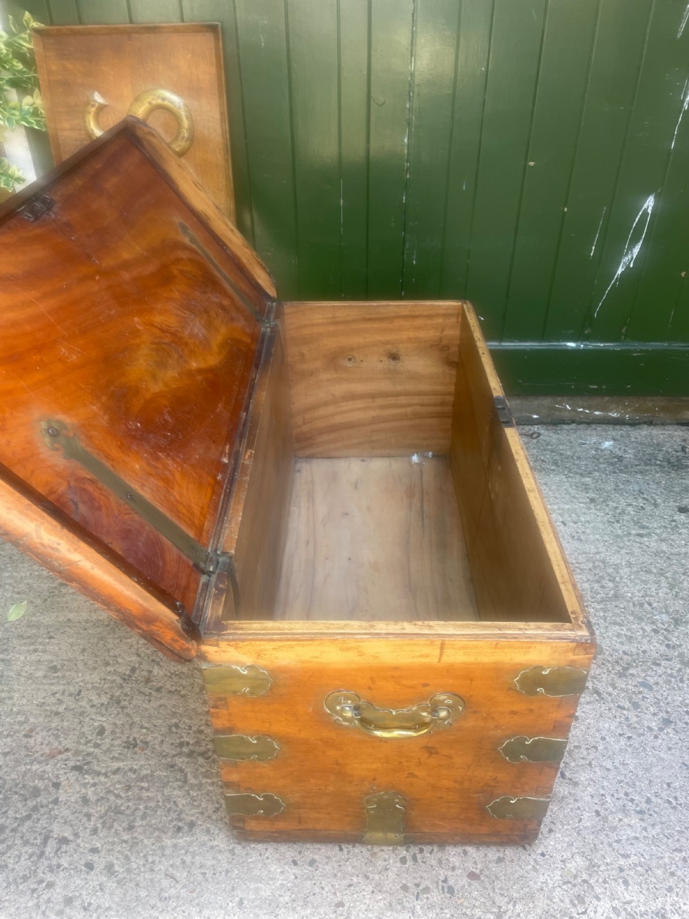 A mid-eighteenth century solid cedar trunk featuring decorative brass corner brackets, brass straps, and a central brass keyhole escutcheon. View XIV
