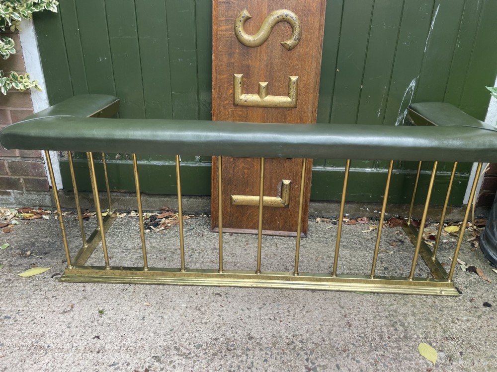 Early C20th Edwardian period polished brass and leather seated ‘club’ fender of restrained design.