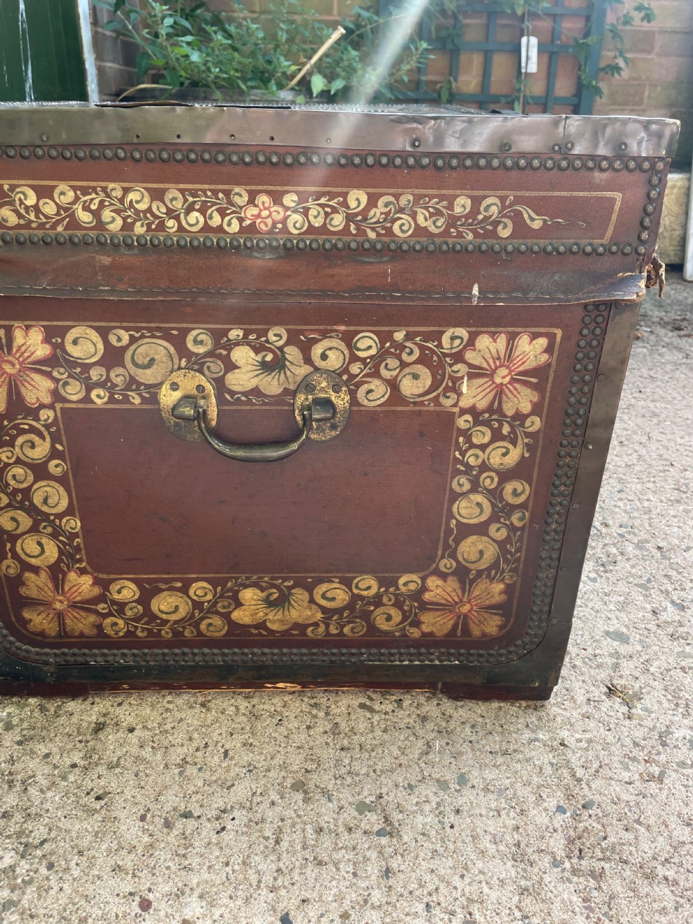 A 19th-century Chinese export leather trunk decorated with hand-painted gold and red floral motifs and brass stud borders. View VII