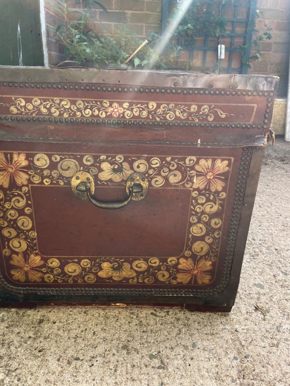 A 19th-century Chinese export leather trunk decorated with hand-painted gold and red floral motifs and brass stud borders. View VIII