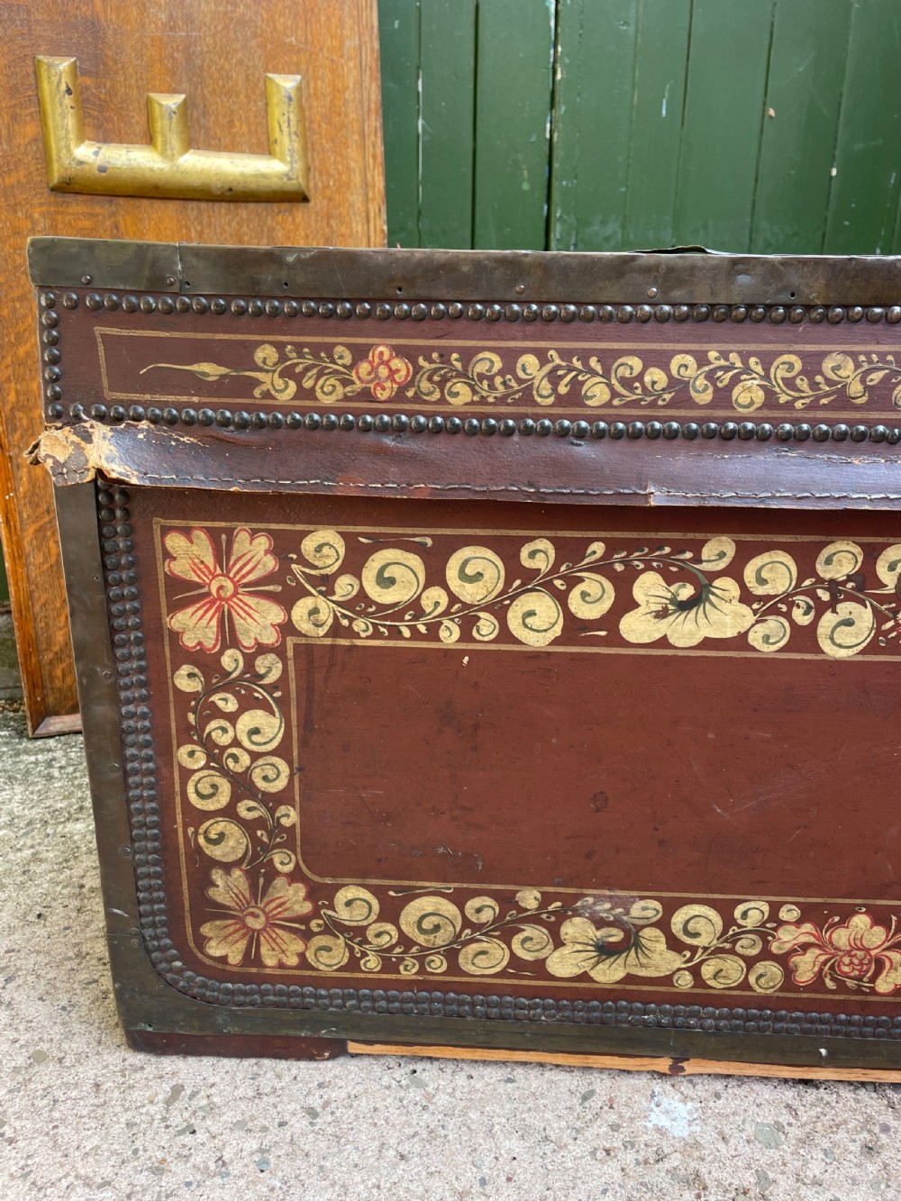 A 19th-century Chinese export leather trunk decorated with hand-painted gold and red floral motifs and brass stud borders. View XI