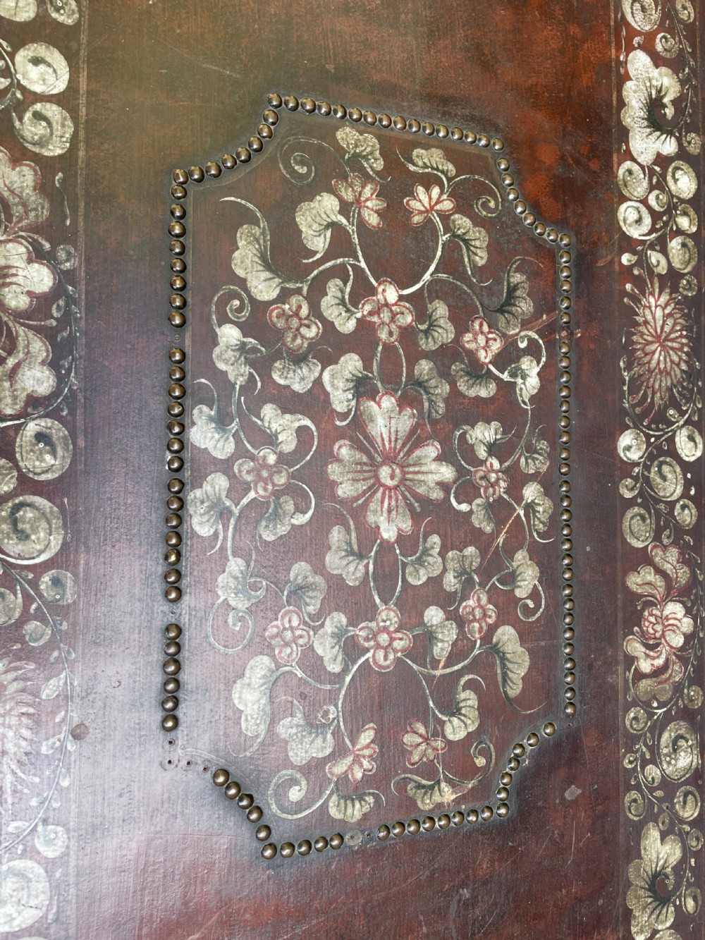 A 19th-century Chinese export leather trunk decorated with hand-painted gold and red floral motifs and brass stud borders. View XIII