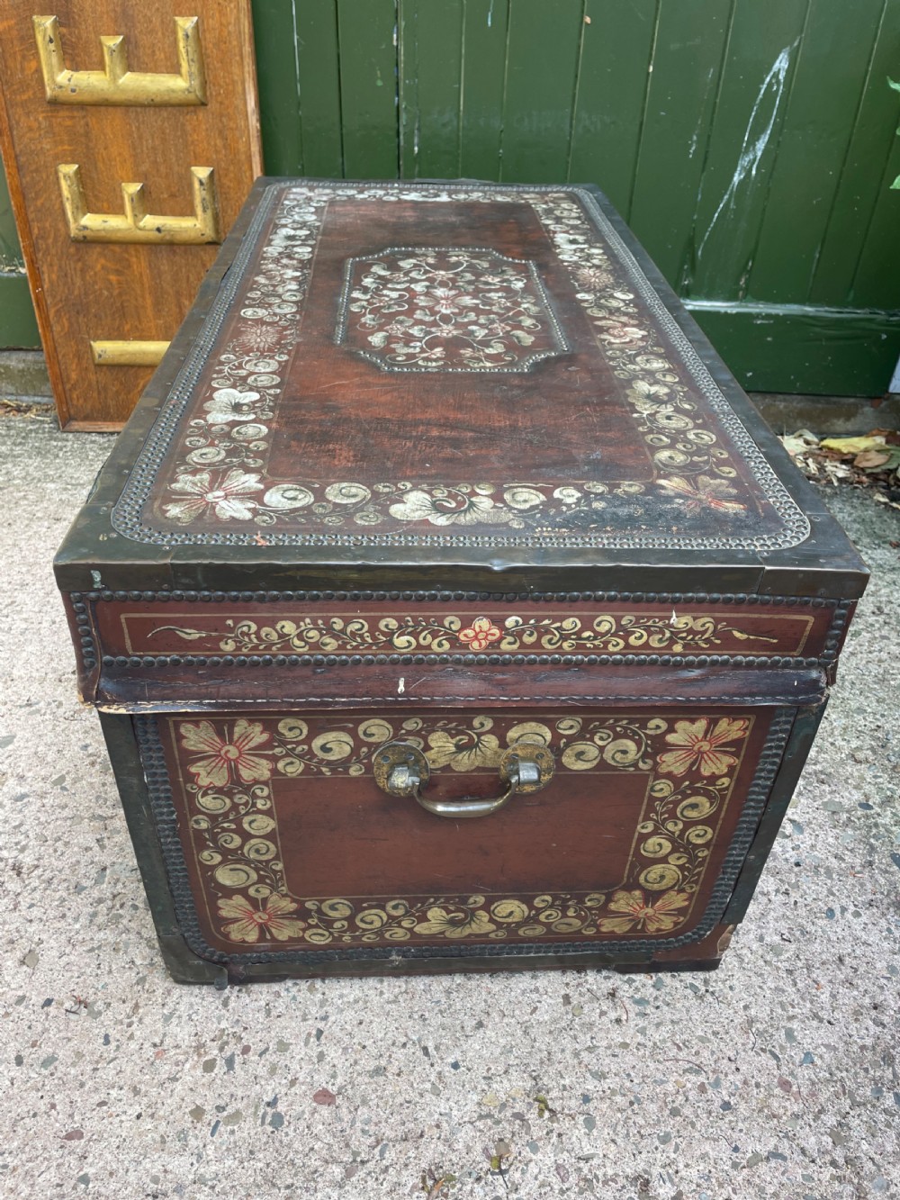 A 19th-century Chinese export leather trunk decorated with hand-painted gold and red floral motifs and brass stud borders. View XV