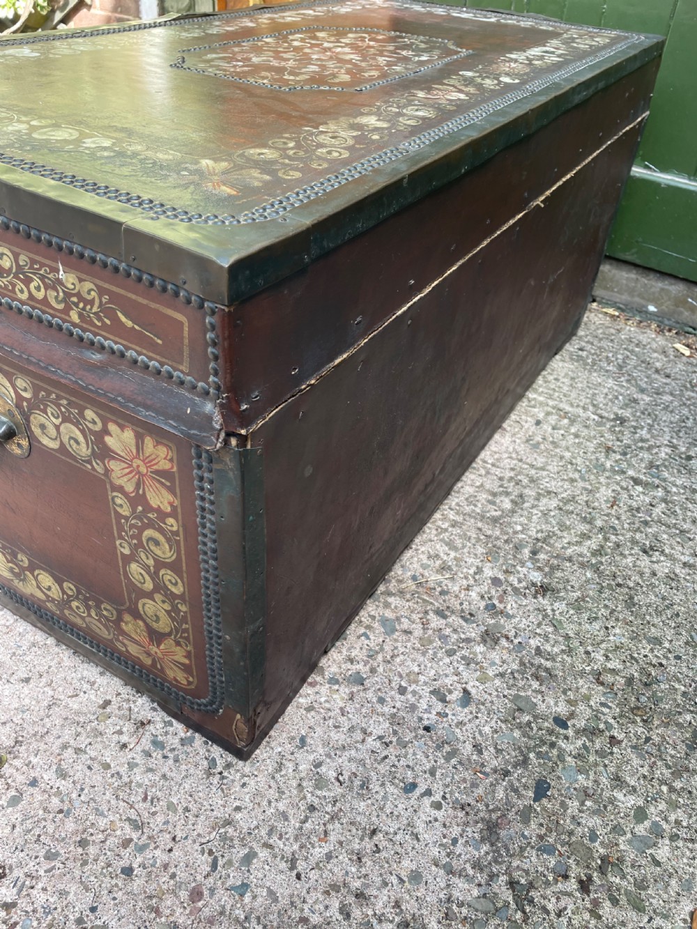 A 19th-century Chinese export leather trunk decorated with hand-painted gold and red floral motifs and brass stud borders. View XVIII