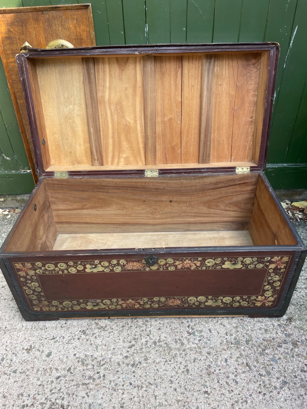 A 19th-century Chinese export leather trunk decorated with hand-painted gold and red floral motifs and brass stud borders. View XIX
