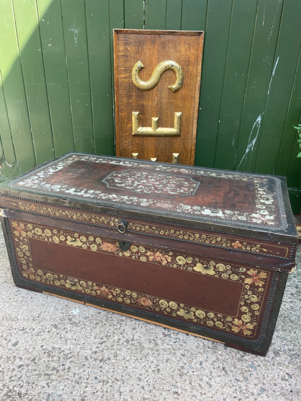 A 19th-century Chinese export leather trunk decorated with hand-painted gold and red floral motifs and brass stud borders. View XXV