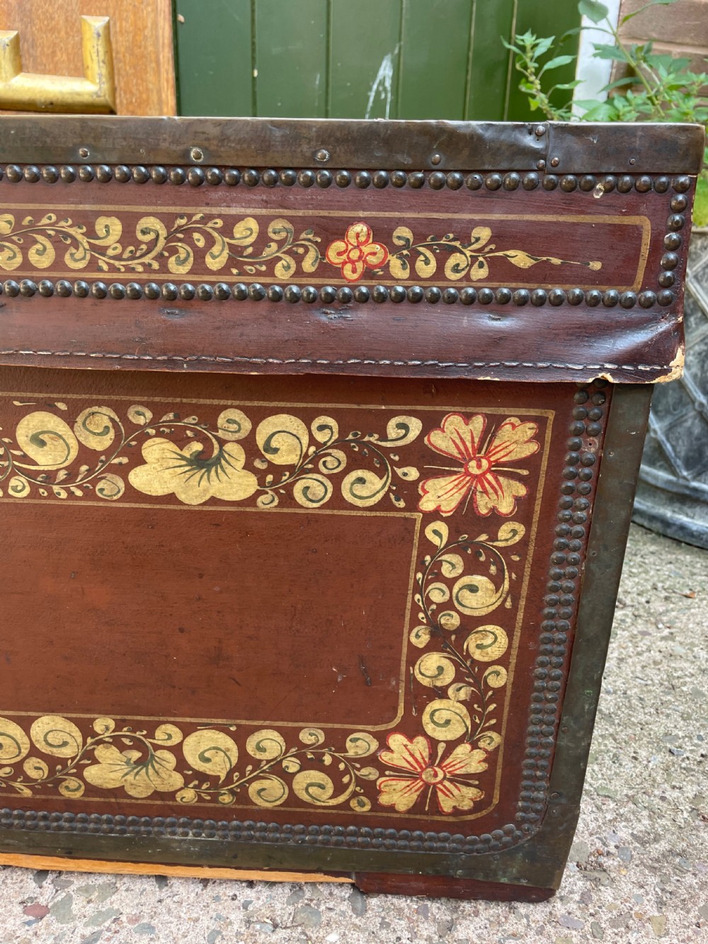 A 19th-century Chinese export leather trunk decorated with hand-painted gold and red floral motifs and brass stud borders. View XXVI