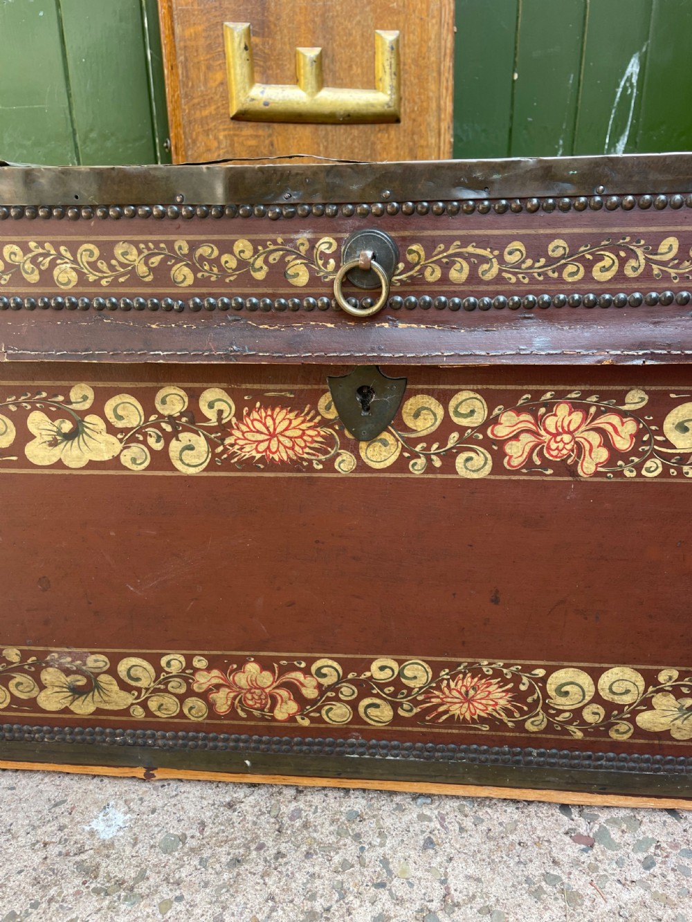 A 19th-century Chinese export leather trunk decorated with hand-painted gold and red floral motifs and brass stud borders. View XXVII