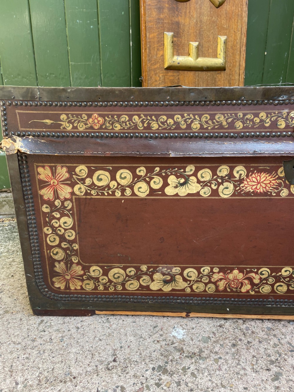 A 19th-century Chinese export leather trunk decorated with hand-painted gold and red floral motifs and brass stud borders. View XXVIII