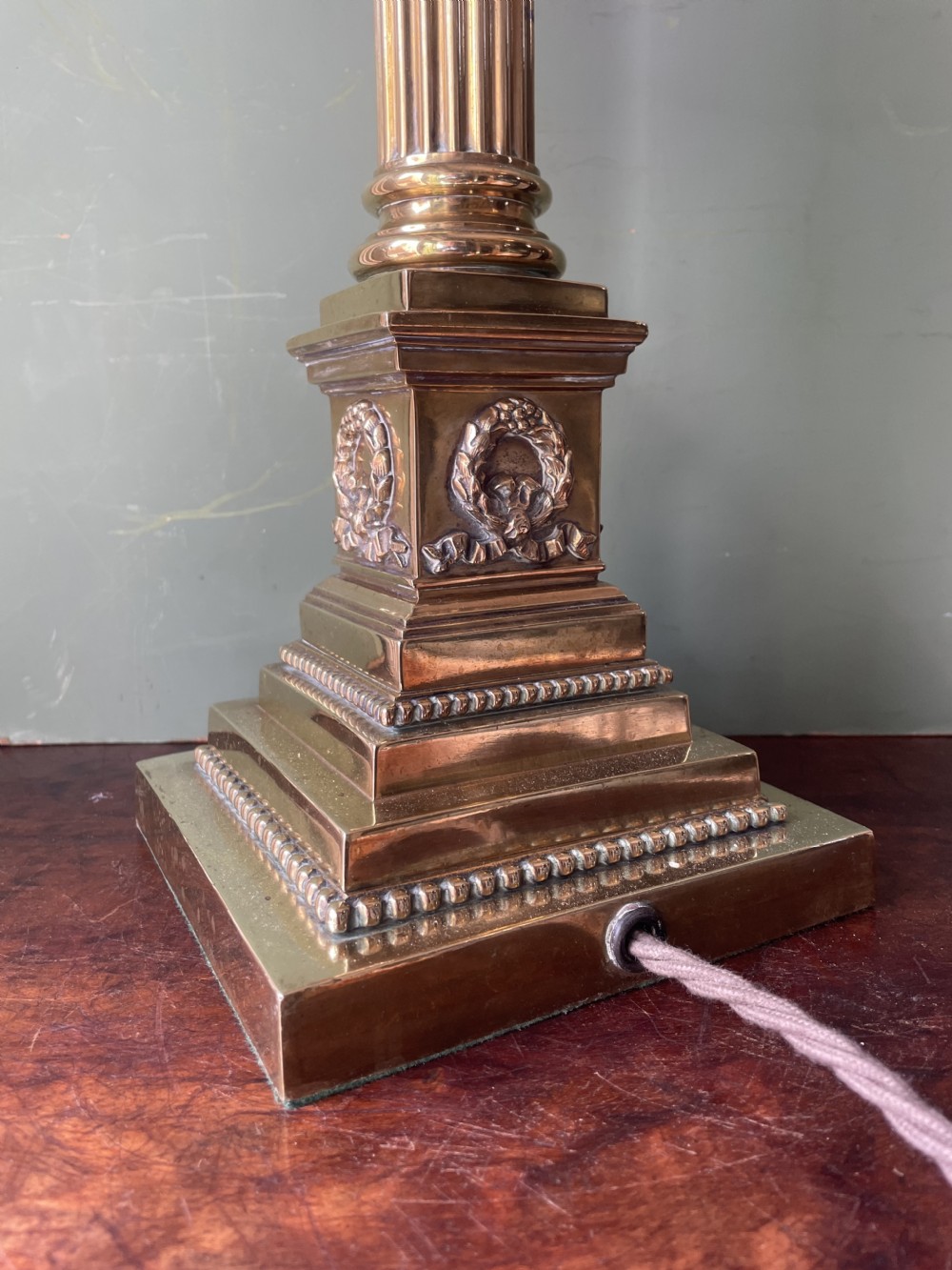 A late 19th-century brass table lamp styled as a classical fluted column with a stepped base and laurel wreath detail. View VIII