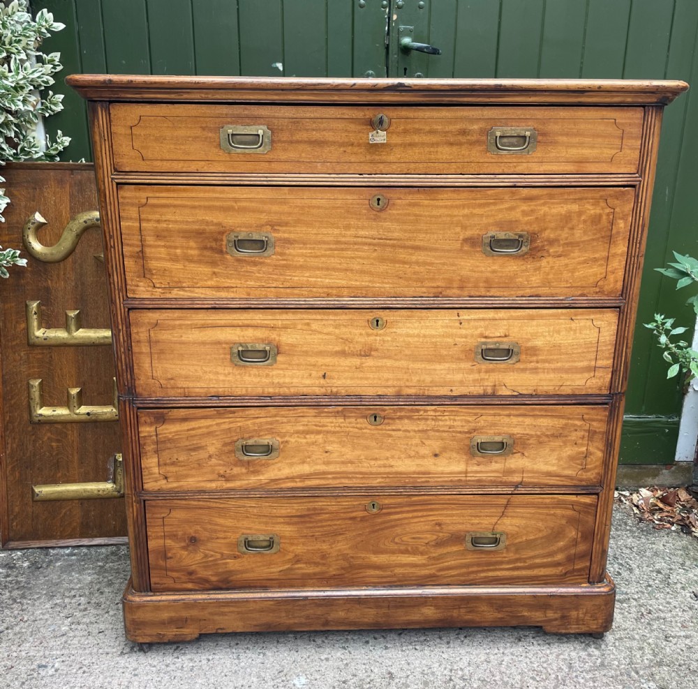 A nineteenth-century two-section camphorwood military campaign chest of drawers with flush brass handles and keyhole escutcheons. View IV