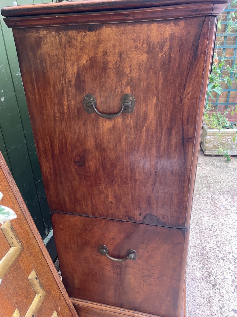 A nineteenth-century two-section camphorwood military campaign chest of drawers with flush brass handles and keyhole escutcheons. View VI
