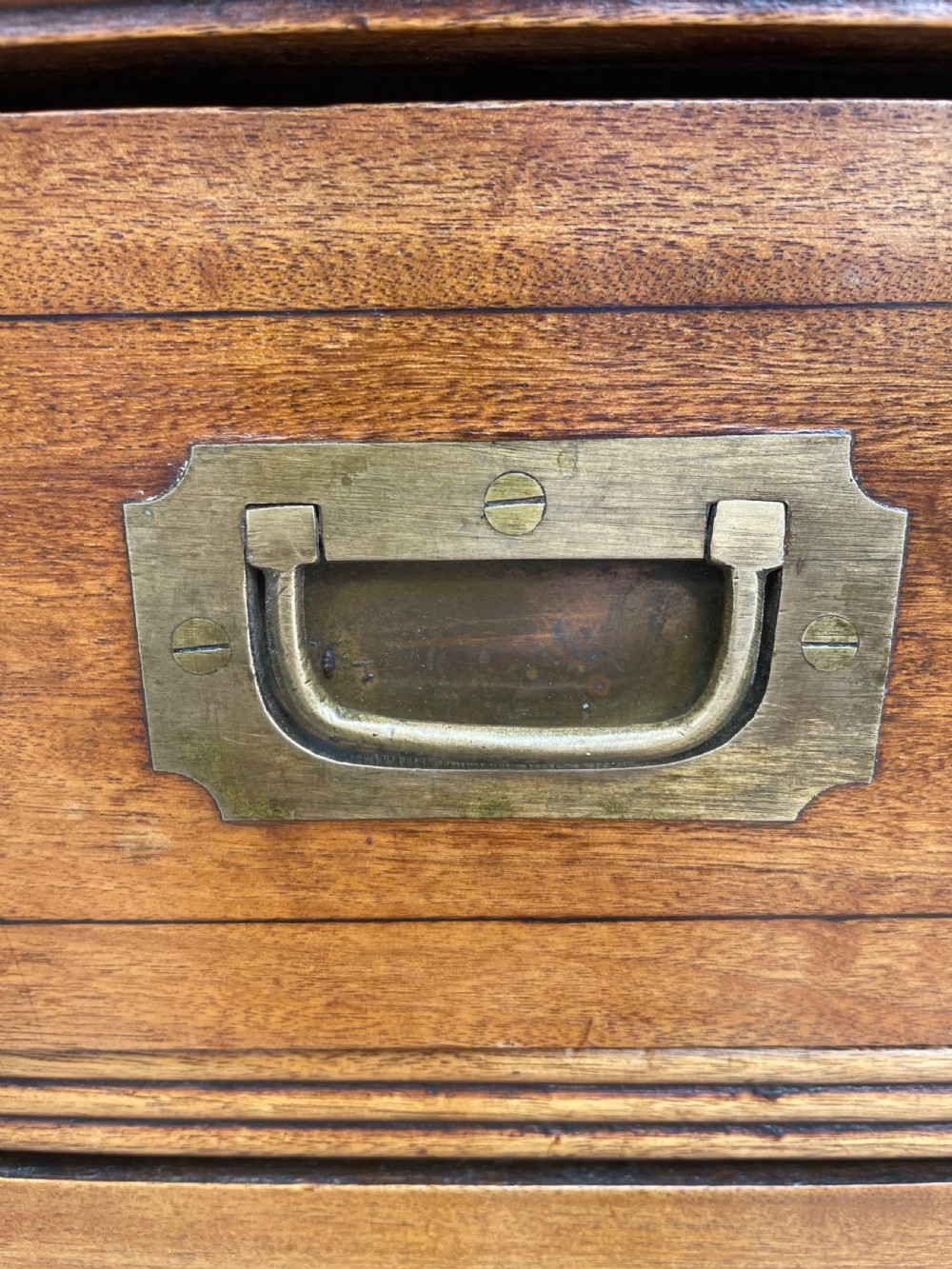 A nineteenth-century two-section camphorwood military campaign chest of drawers with flush brass handles and keyhole escutcheons. View VIII