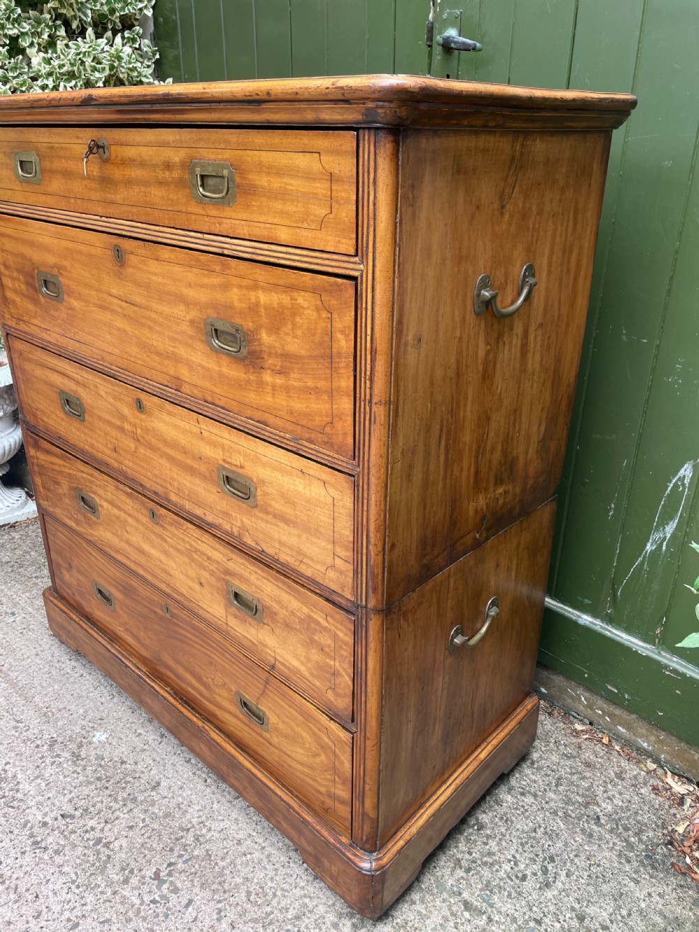 A nineteenth-century two-section camphorwood military campaign chest of drawers with flush brass handles and keyhole escutcheons. View XI