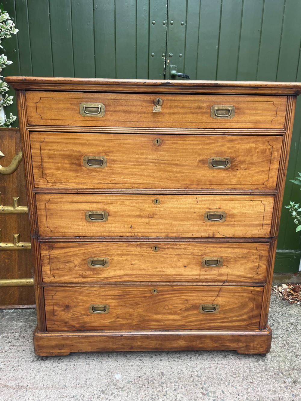 A nineteenth-century two-section camphorwood military campaign chest of drawers with flush brass handles and keyhole escutcheons. View XII