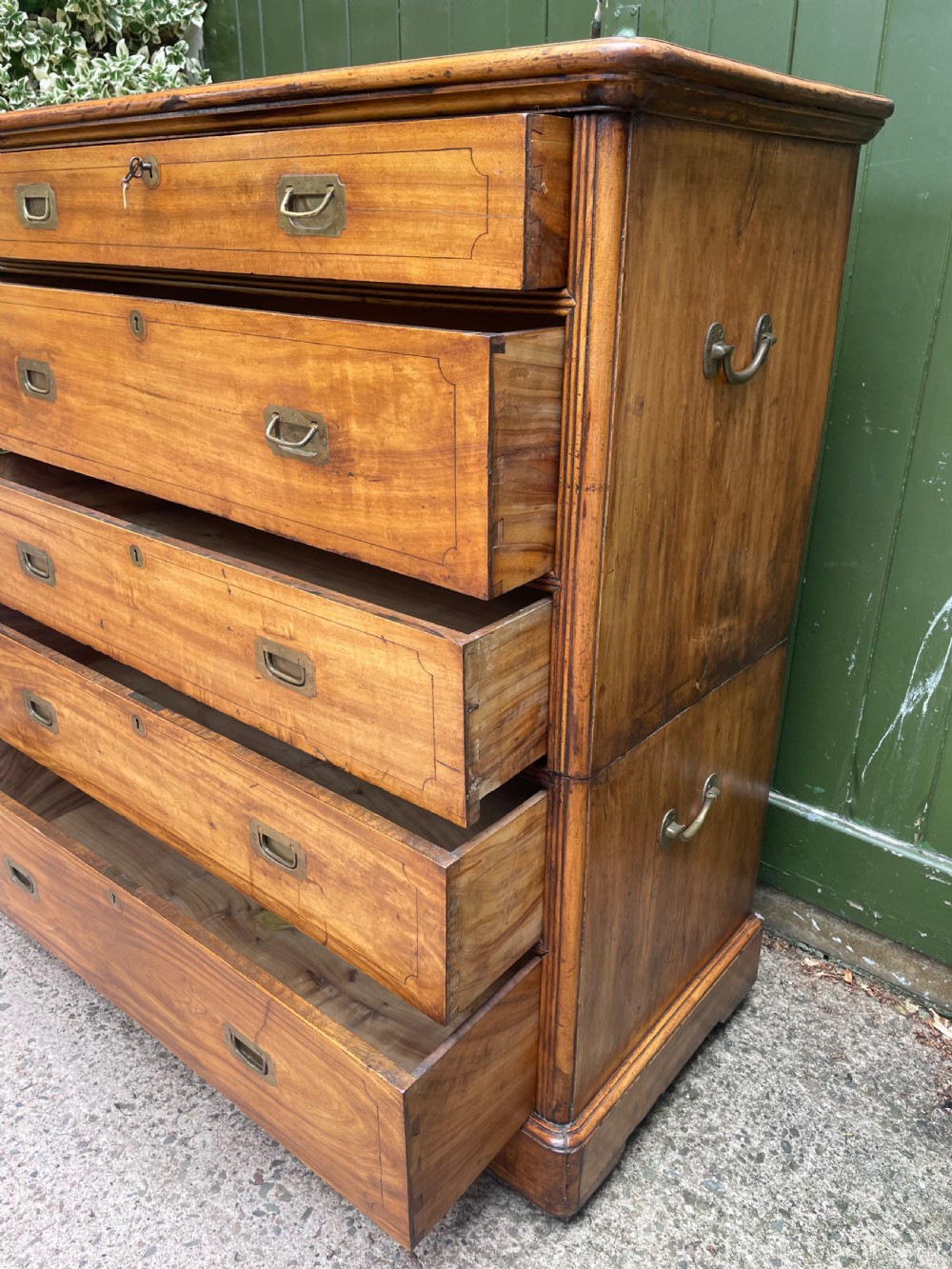 A nineteenth-century two-section camphorwood military campaign chest of drawers with flush brass handles and keyhole escutcheons. View XIII