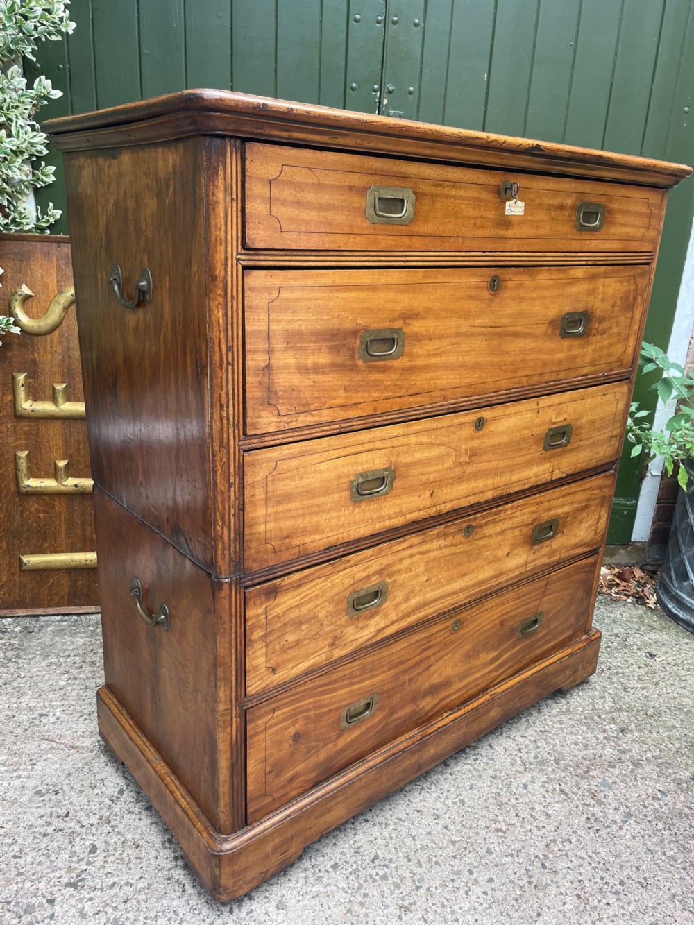 A nineteenth-century two-section camphorwood military campaign chest of drawers with flush brass handles and keyhole escutcheons. View XIV