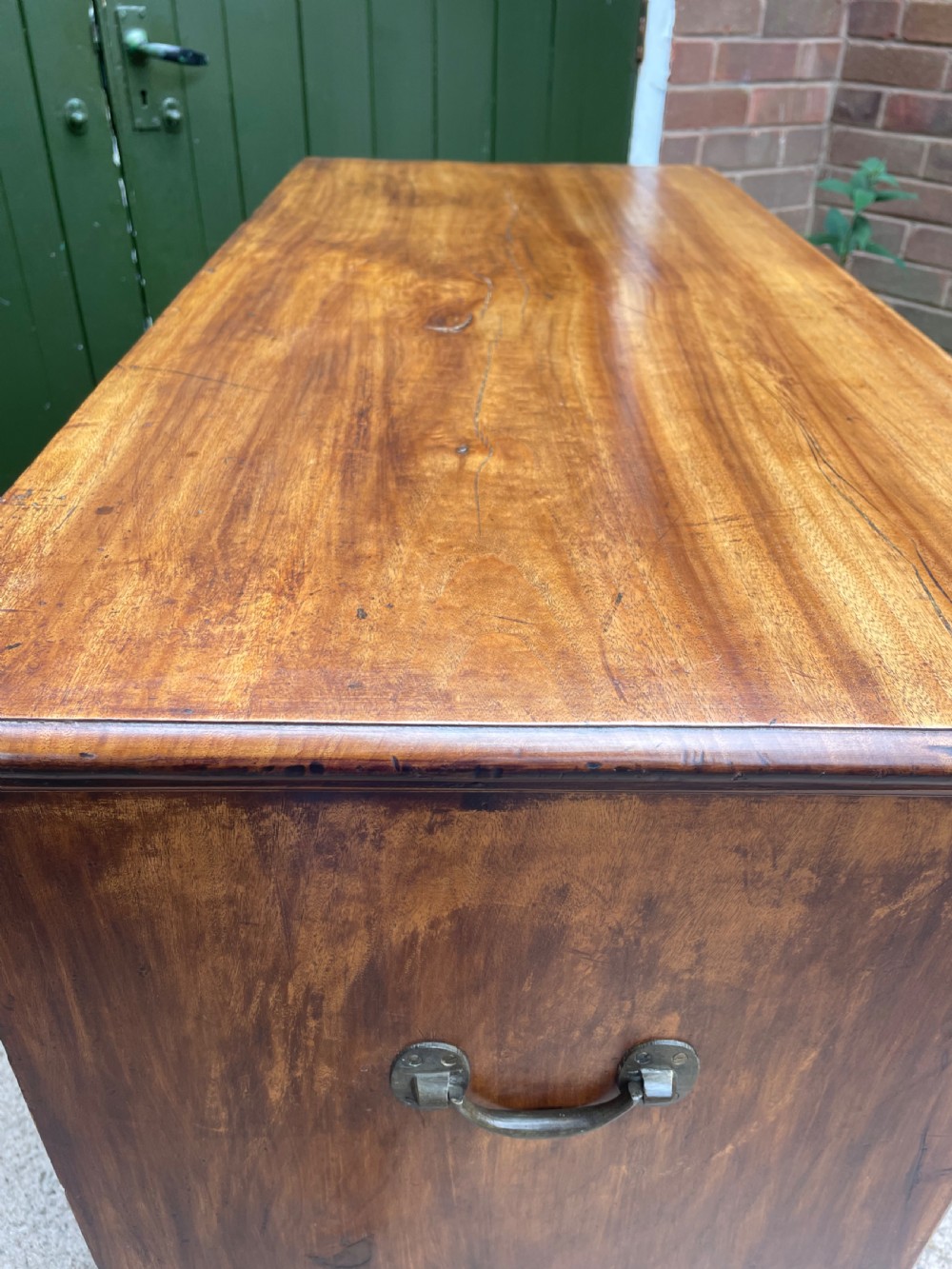 A nineteenth-century two-section camphorwood military campaign chest of drawers with flush brass handles and keyhole escutcheons. View XVI