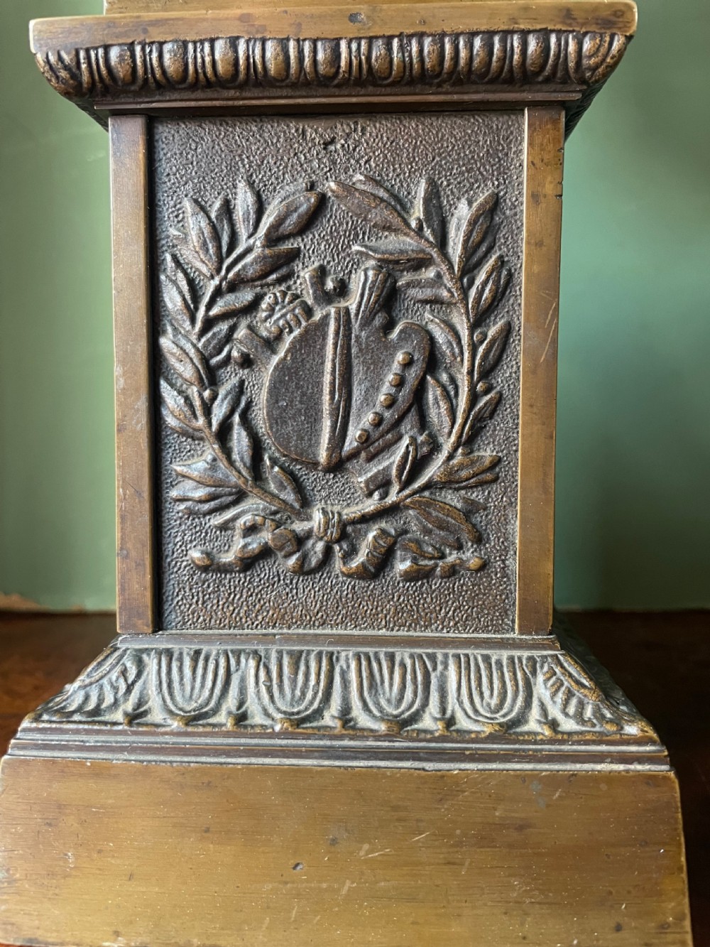 A pair of early 19th-century French Charles X bronze campana-shaped urns with fluted bodies and classical relief motifs on square plinth bases. View X