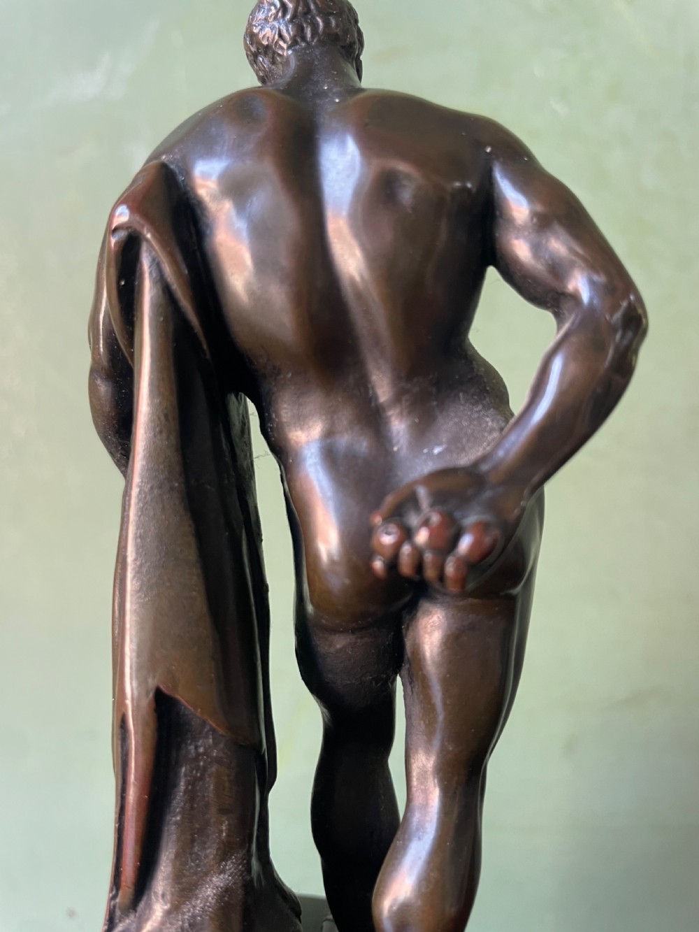 A patinated bronze study of the Farnese Hercules standing against a club draped in lion skin, mounted on a red marble plinth and black base. View XIII