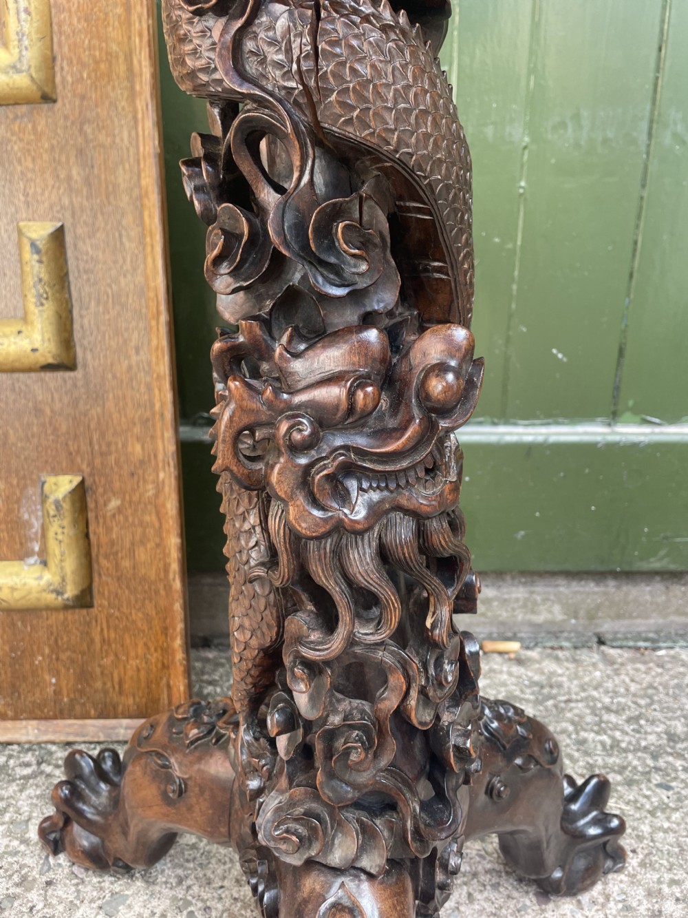 A late nineteenth-century Chinese dark hardwood occasional table featuring a round inset marble top, intricately carved dragon column, and a tripod base. View VII