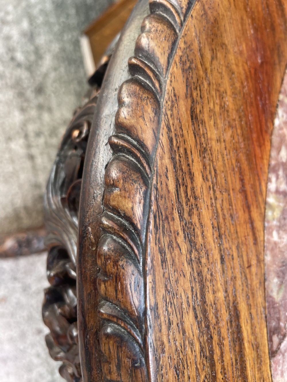 A late nineteenth-century Chinese dark hardwood occasional table featuring a round inset marble top, intricately carved dragon column, and a tripod base. View XVI