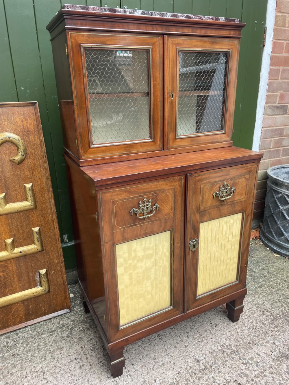 Elegant early C19th small-scale mahogany 4 door 2-part glazed cabinet having brass line inlay and brass mouldings , together with a ‘rosso levanto’ marble top. View III
