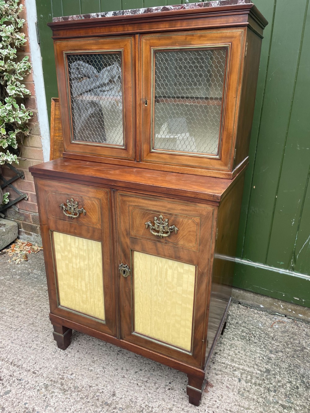 Elegant early C19th small-scale mahogany 4 door 2-part glazed cabinet having brass line inlay and brass mouldings , together with a ‘rosso levanto’ marble top. View IV