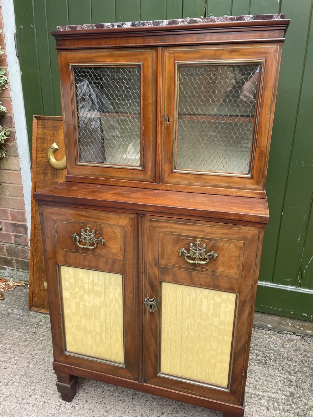 Elegant early C19th small-scale mahogany 4 door 2-part glazed cabinet having brass line inlay and brass mouldings , together with a ‘rosso levanto’ marble top. View XI