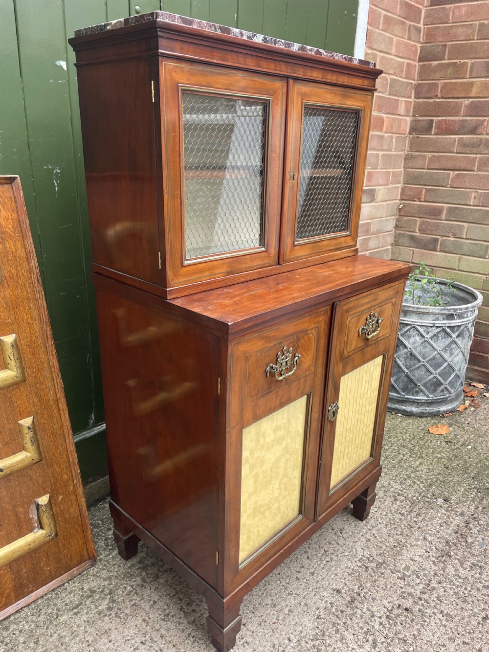 Elegant early C19th small-scale mahogany 4 door 2-part glazed cabinet having brass line inlay and brass mouldings , together with a ‘rosso levanto’ marble top. View XIX