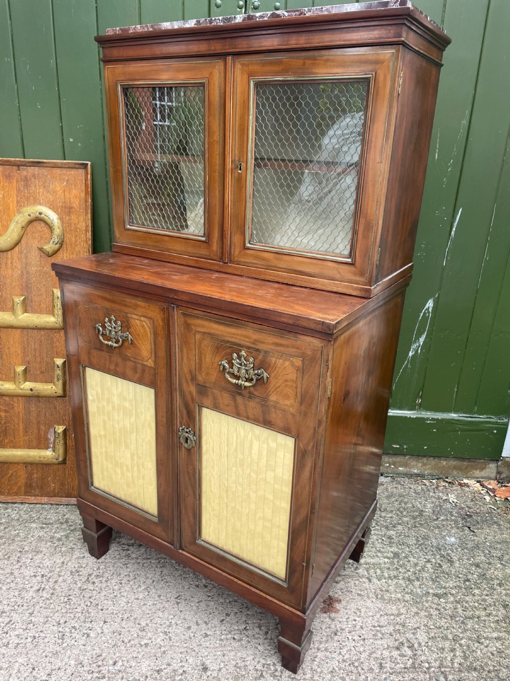 Elegant early C19th small-scale mahogany 4 door 2-part glazed cabinet having brass line inlay and brass mouldings , together with a ‘rosso levanto’ marble top. View XXIII