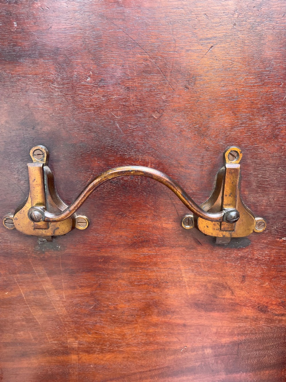 A late George III period circular mahogany tilt-top table shown in a vertical position, featuring a single-piece top and reeded tripod legs with brass castors. View IX