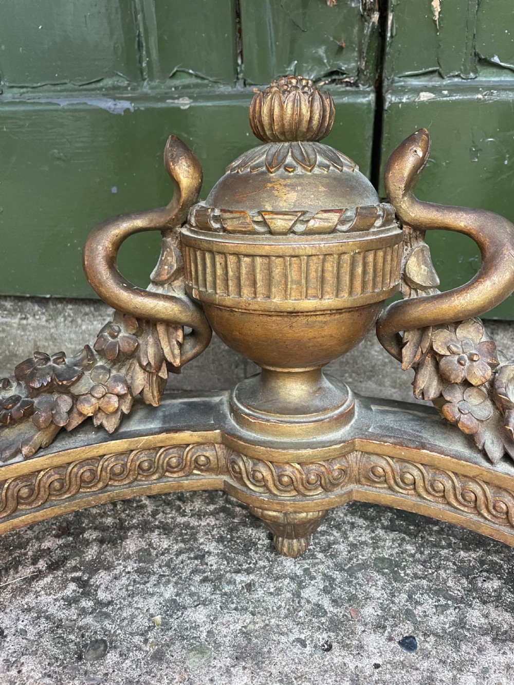 A 19th-century French giltwood console table featuring a serpentine variegated marble top, pierced lattice frieze, and carved urn stretcher. View III