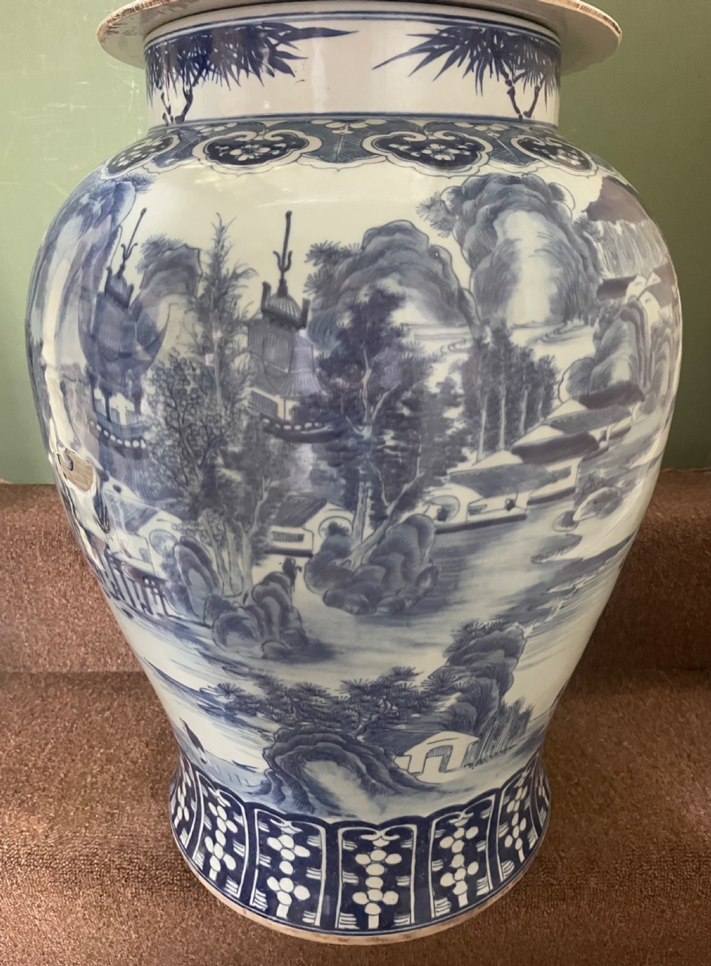A large Qing dynasty style blue and white porcelain ginger jar with a domed lid decorated with hand-painted traditional Chinese landscape scenes. View III