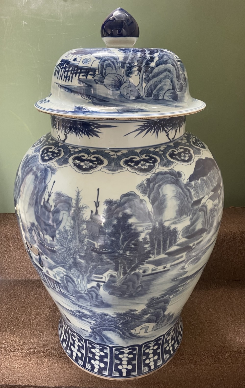 A large Qing dynasty style blue and white porcelain ginger jar with a domed lid decorated with hand-painted traditional Chinese landscape scenes. View VI