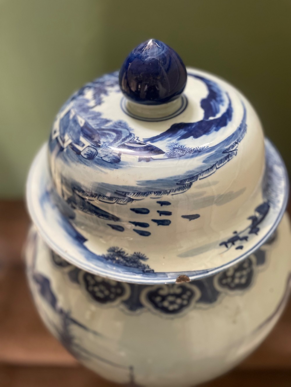 A large Qing dynasty style blue and white porcelain ginger jar with a domed lid decorated with hand-painted traditional Chinese landscape scenes. View X