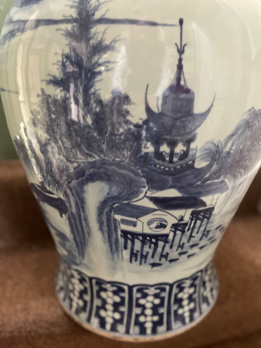 A large Qing dynasty style blue and white porcelain ginger jar with a domed lid decorated with hand-painted traditional Chinese landscape scenes. View XII